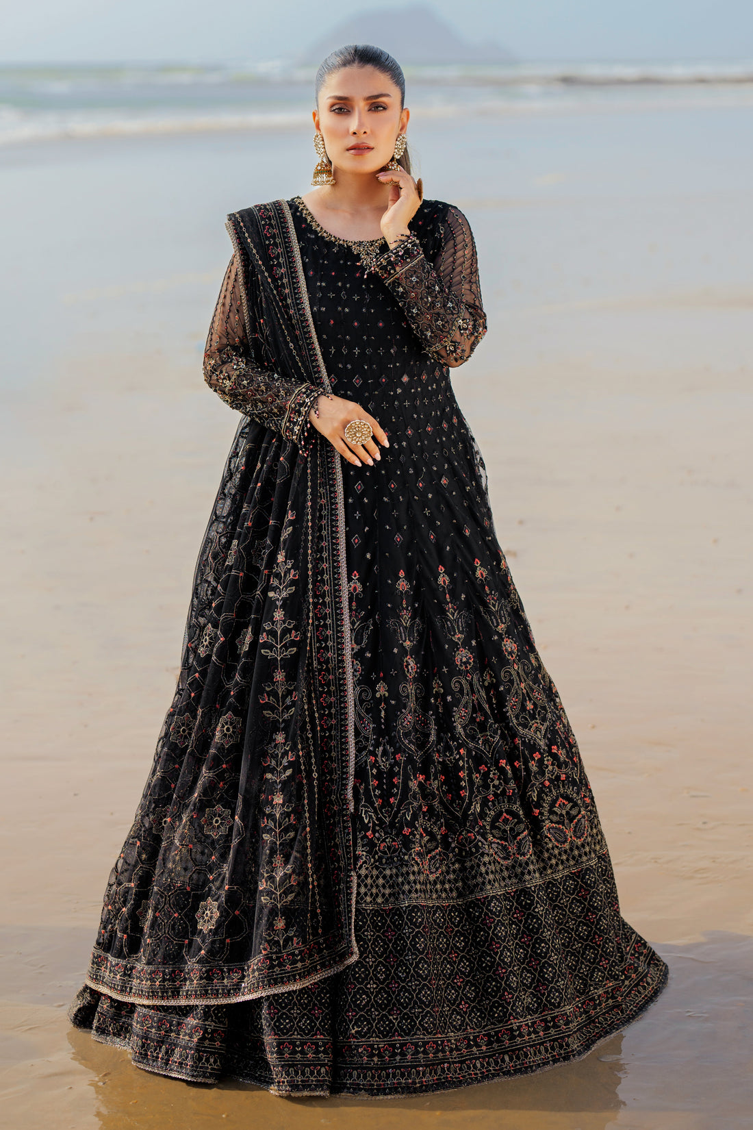 NAQSHI Blain black net maxi frock with round adda‑embellished neckline, heavy hand‑adda floral embroidery, sequin accents, contrasting panel details and matching dupatta.