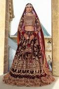 Parivarsh dark maroon velvet bridal lehenga choli by NAQSHI, full front view with heavily embellished choli, flared velvet lehenga, organza dupatta and matching potli bag, ready to wear 4-piece barat wedding outfit.