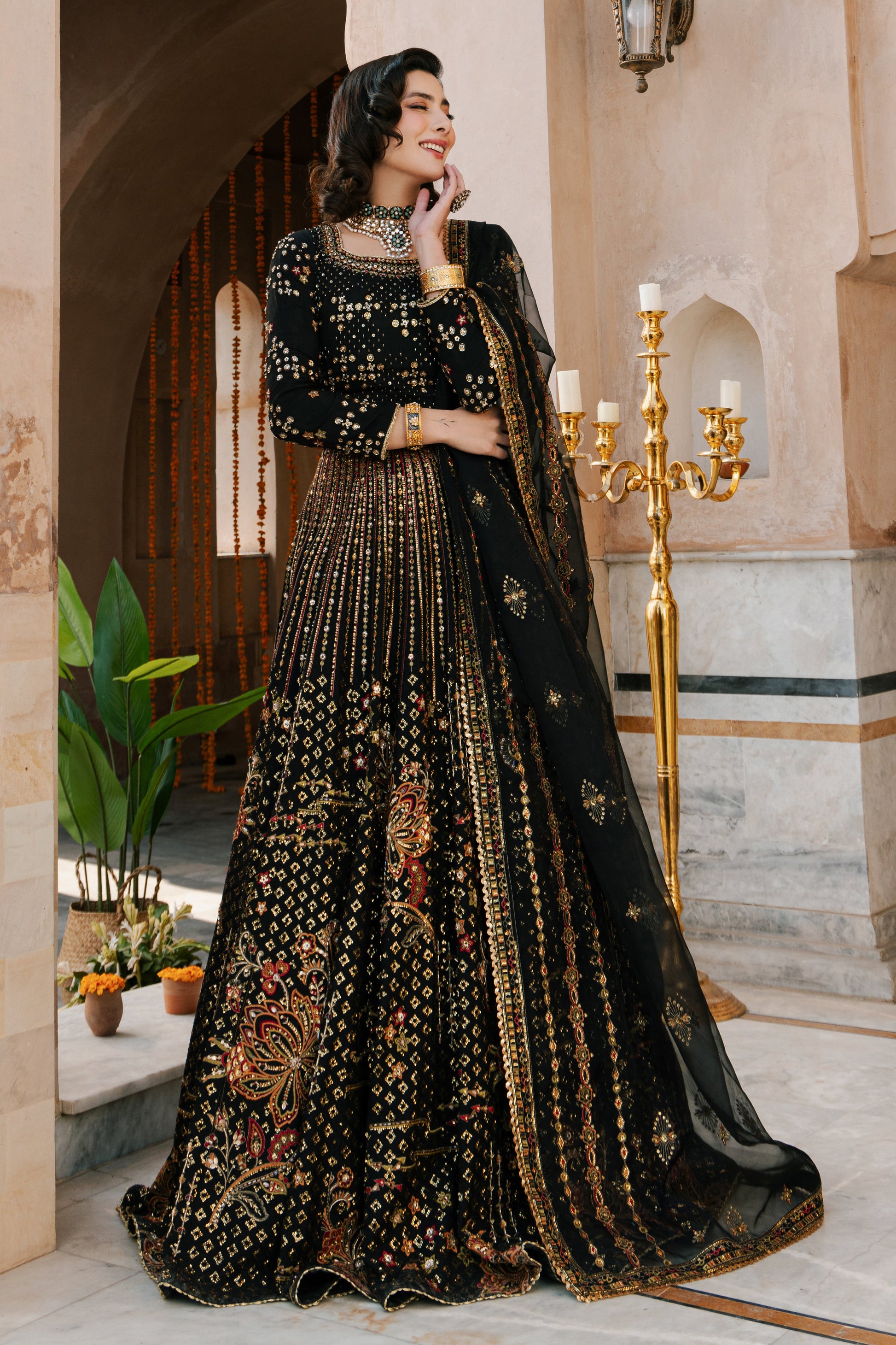 NAQSHI Kaif black Indian raw‑silk lehenga choli with boat neckline, fully hand‑adda embellished choli and heavily jeweled lehenga, styled front on