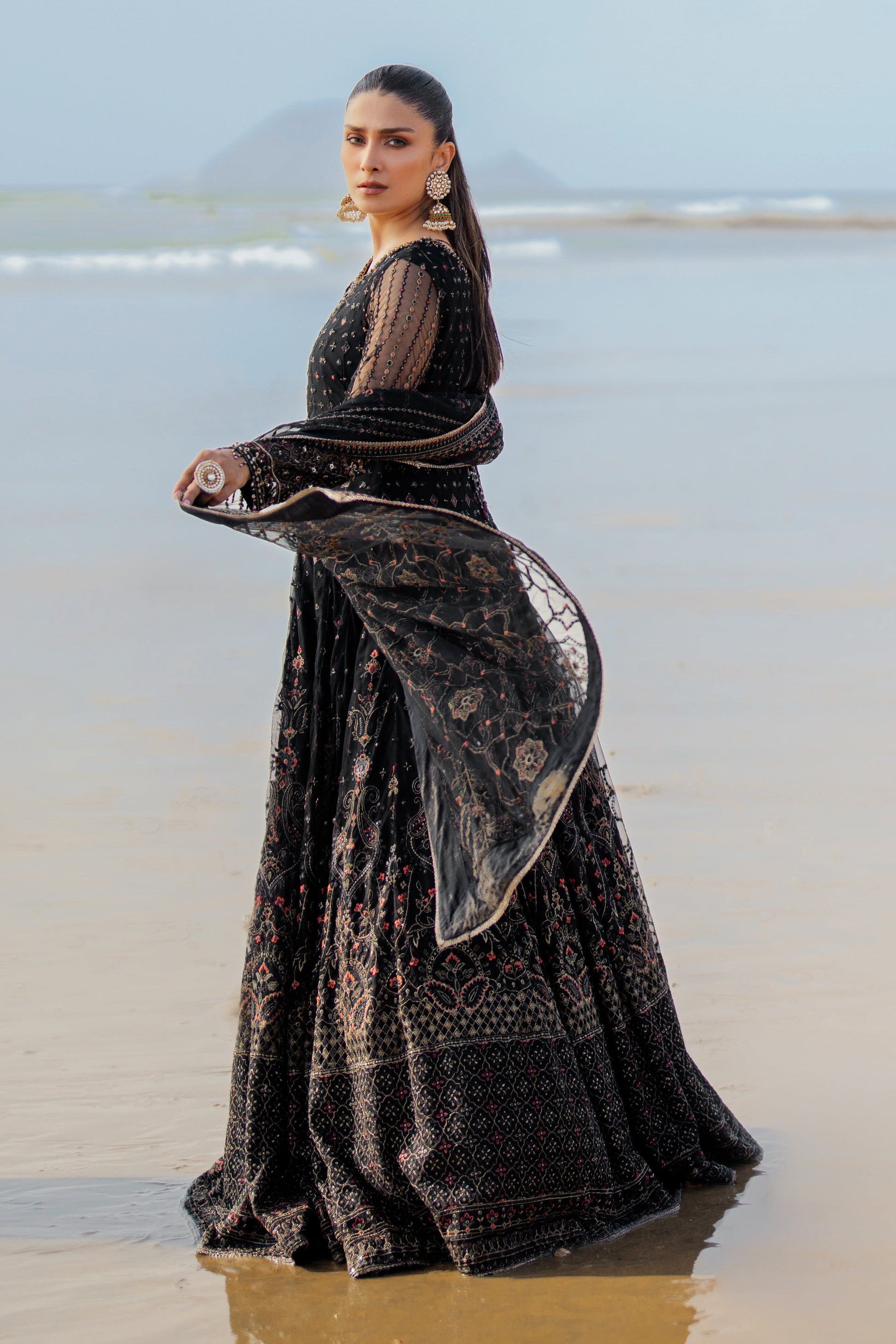 Close‑up of NAQSHI Blain sleeve cuff highlighting floral embroidery, sequin texture and handmade crystal hangings on net fabric.  