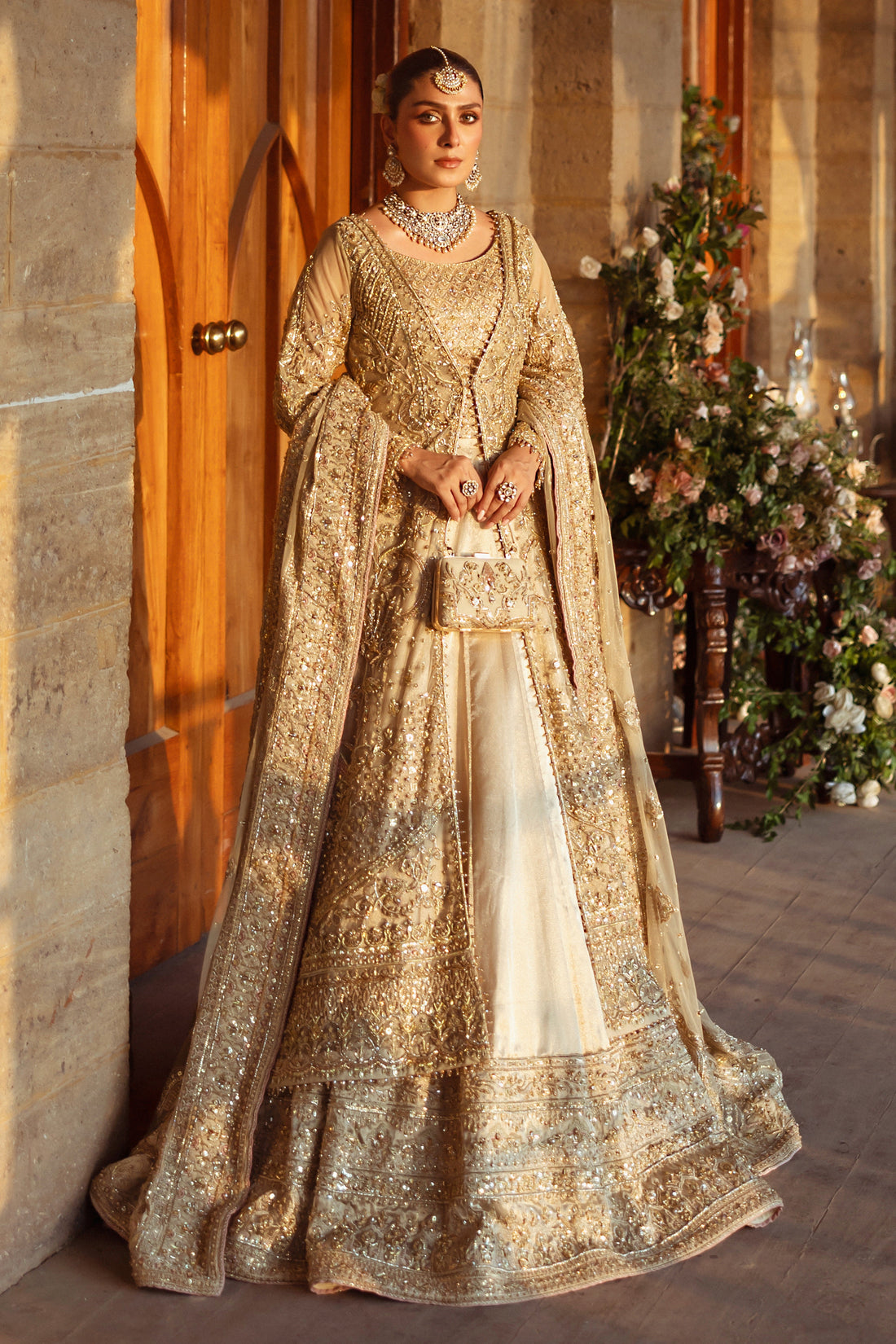 Roshan Ara skin gold bridal gown by NAQSHI, full front view with hand embellished net gown over tissue lehenga, net dupatta and matching clutch, ready to wear 5-piece wedding outfit. 