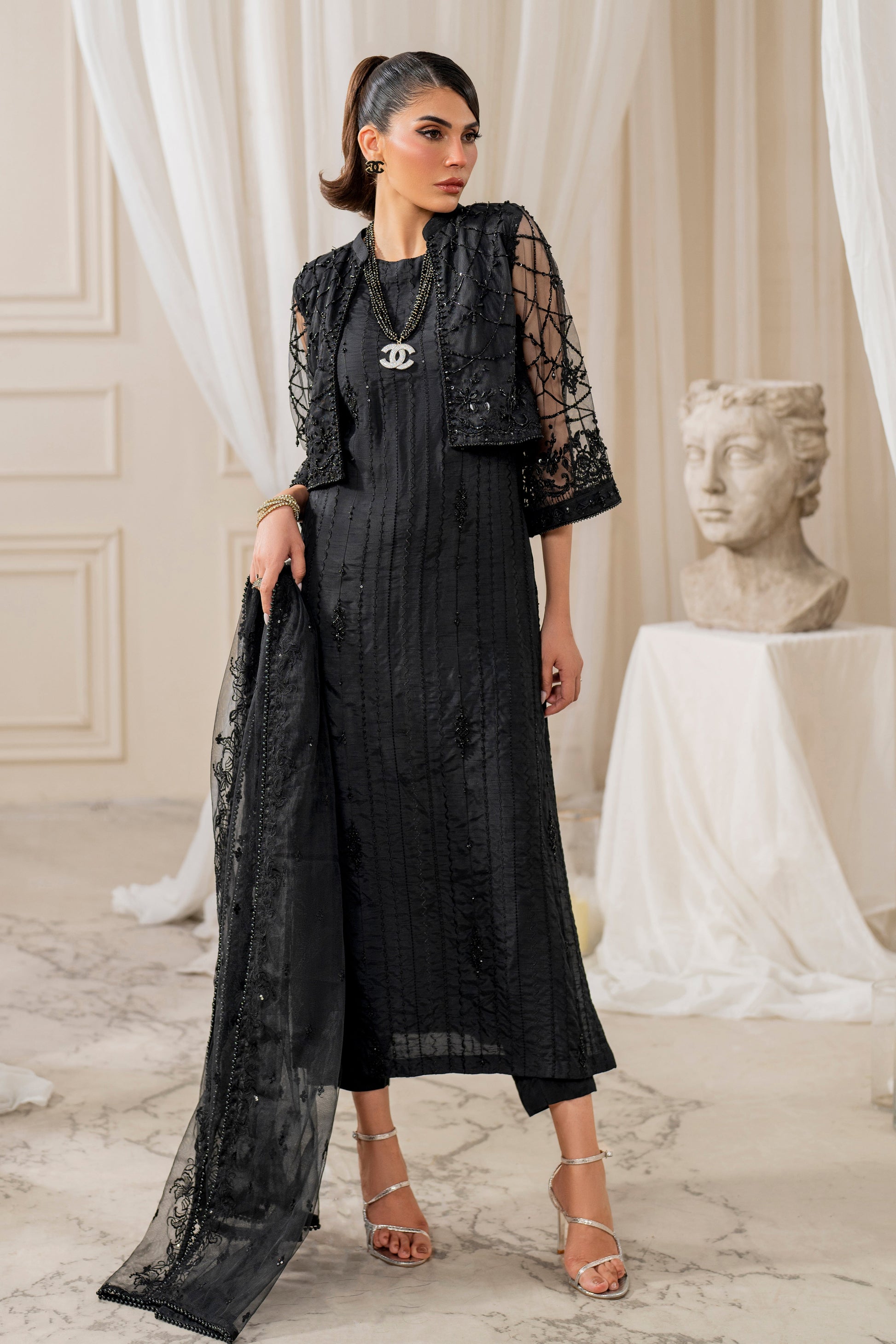 Detailed view of Naqshi siara net dupatta border featuring sequin-lined edge and embroidered trim on sheer black fabric.