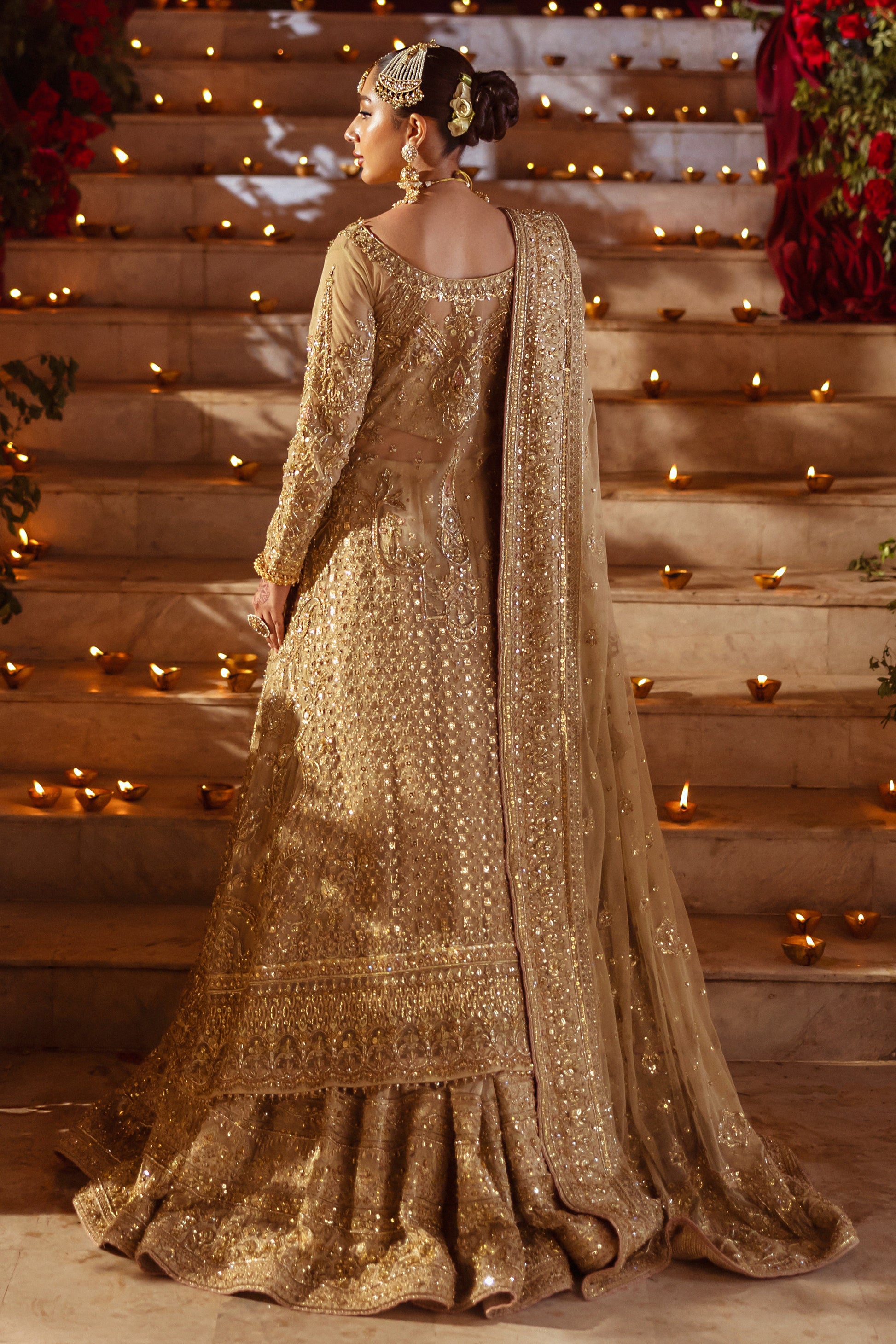 Back side view of Roshan Ara skin gold wedding outfit showing dupatta trail and layered hem detailing, traditional ready made bridal attire