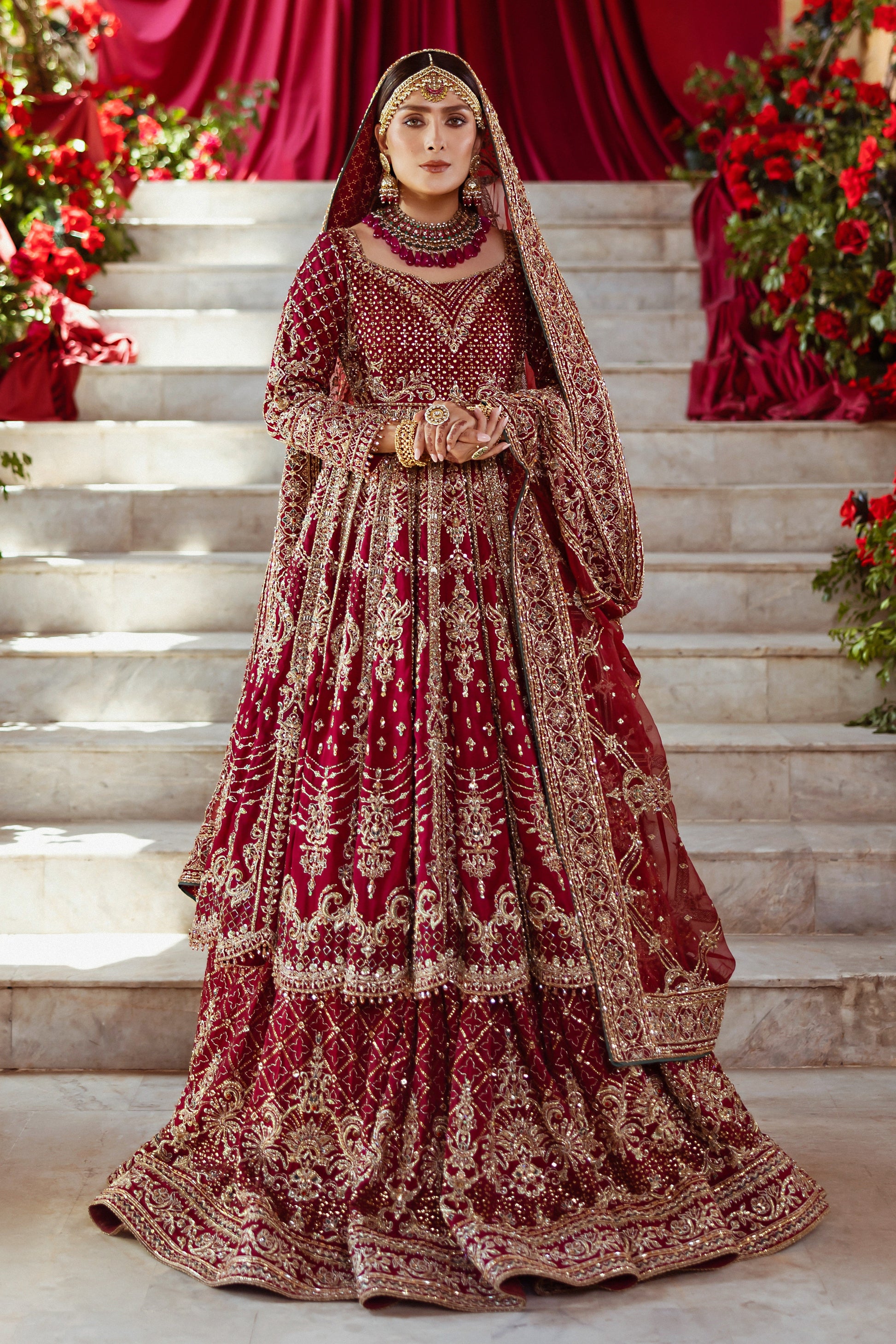 NAQSHI Jhankar garnet-red pure raw-silk kalidar frock with square neckline, fitted sleeves, dense hand-adda embroidery (naqshi, dabka, payal, cut dana, stone, crystal) across bodice, paired with Indian raw-silk lehenga and embellished dupatta.