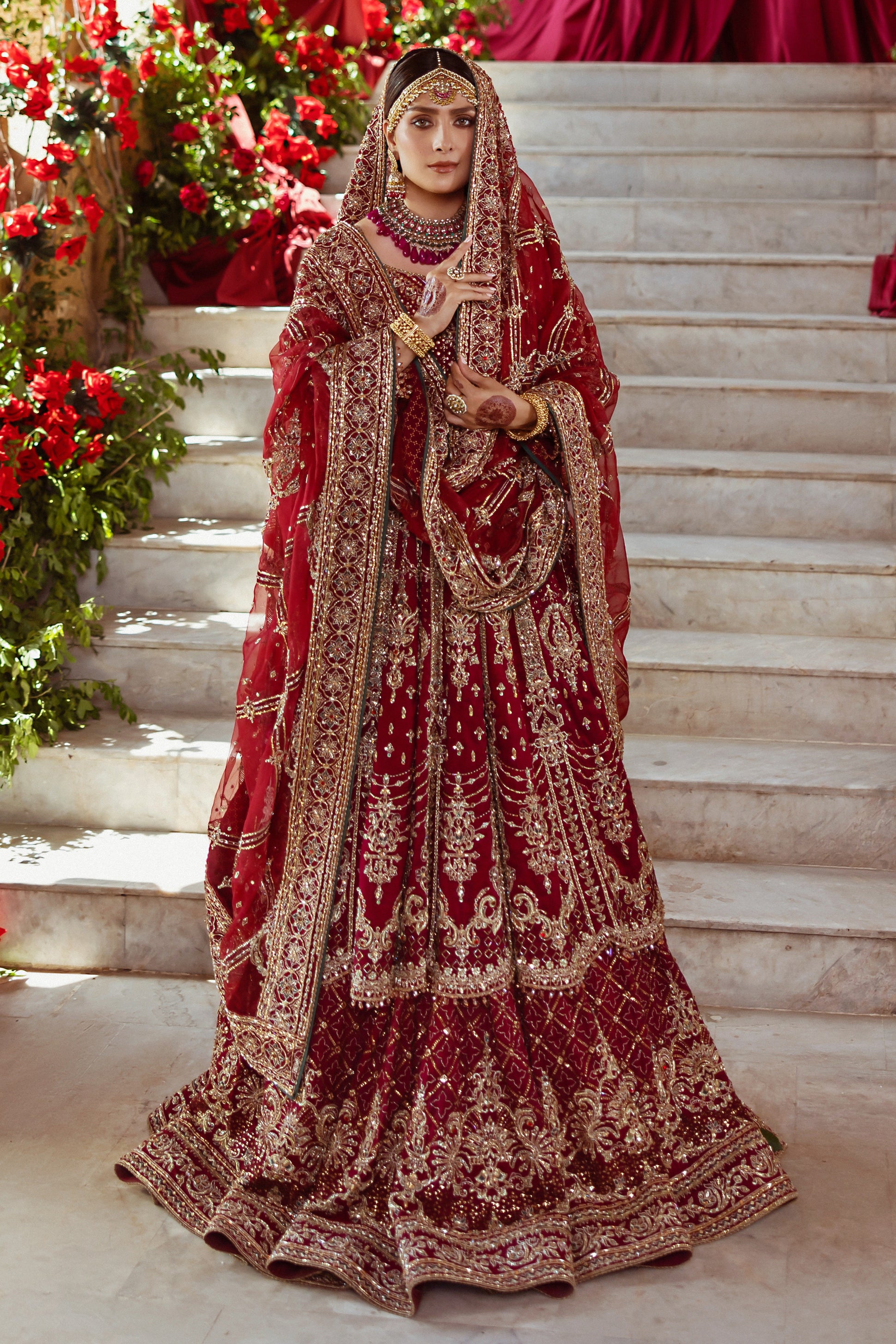 Full standing look of Jhankar garnet red lehenga frock suit with heavy borders and layered flare, complete formal bridal barat attire.