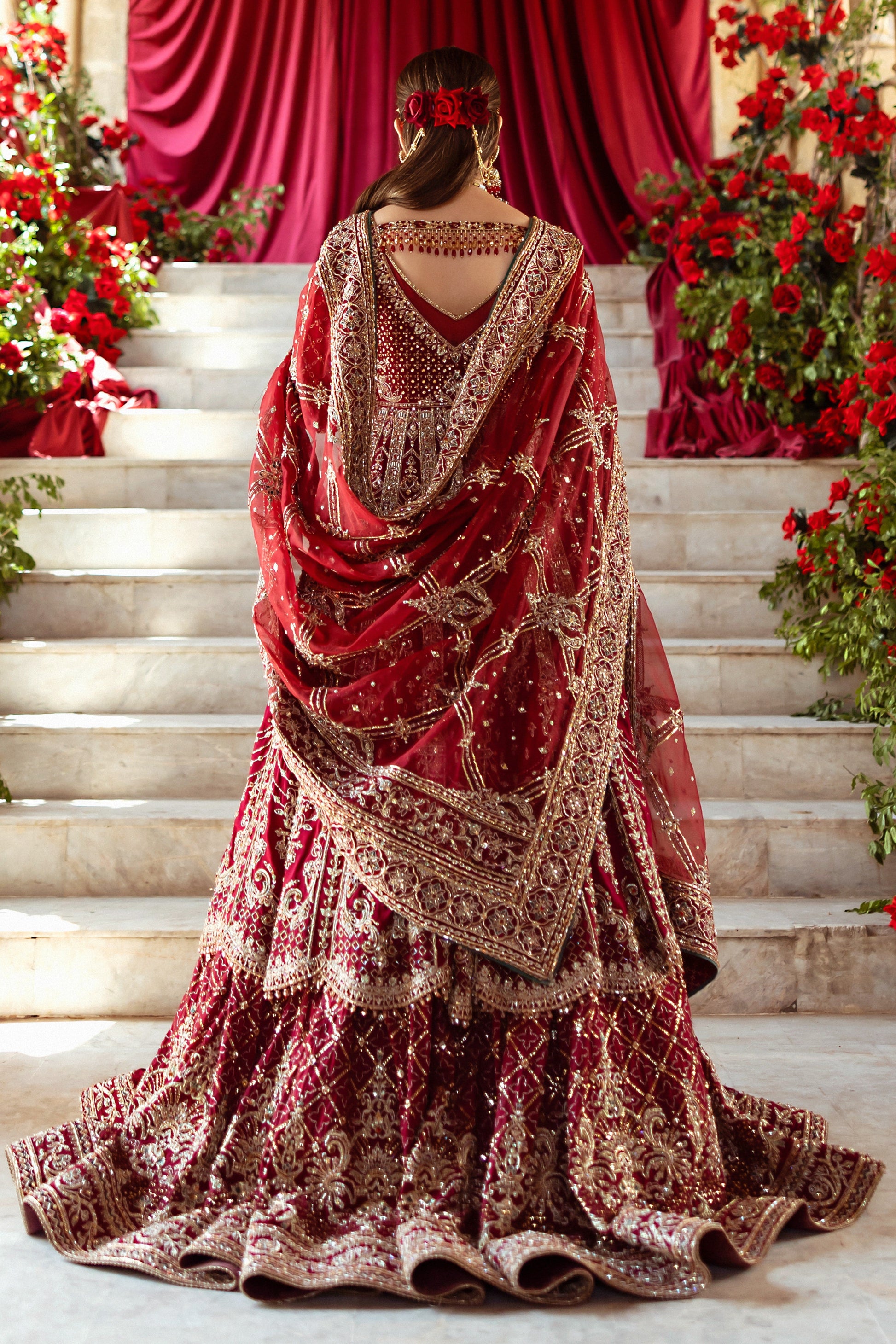 Back view of Jhankar garnet red bridal outfit showing wide kalidar frock flare, lehenga volume and long dupatta fall, traditional ready made barat wedding dress.