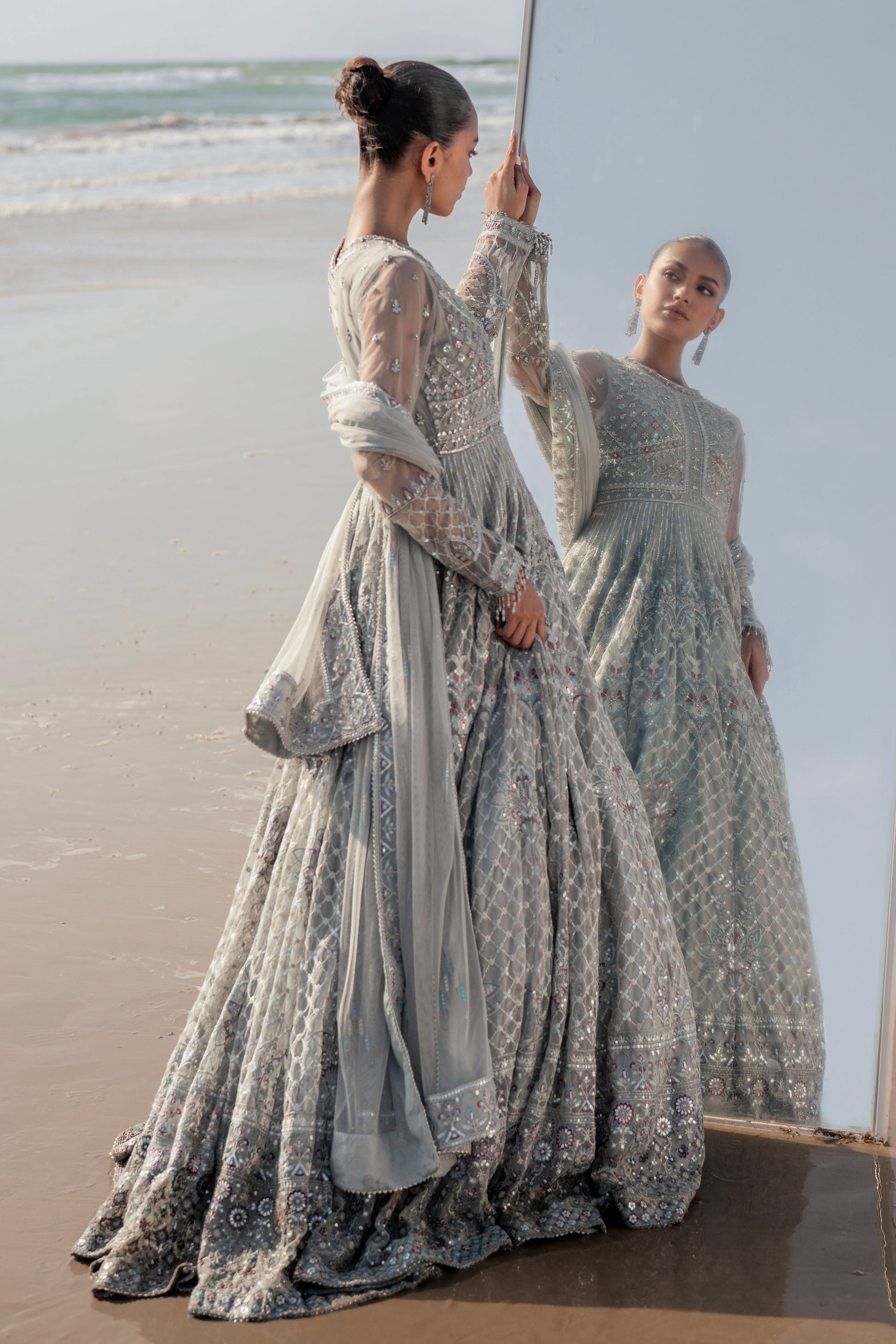  Valeria silver net dupatta draped elegantly, featuring sequin‑line sprays, embroidered luxe pallu border with contrasting hues and delicate floral accents.