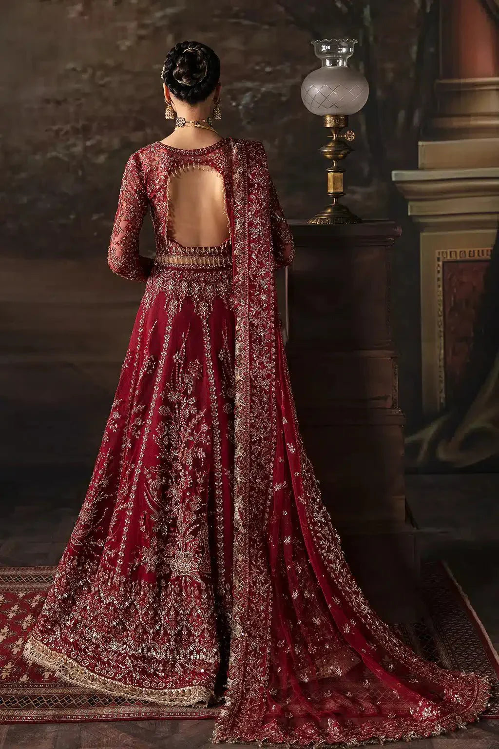 Afrozeh The Brides Edit 23 Emmaine bridal lehnga choli in maroon net with intricate gold embroidery, styled with traditional jewelry.