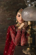 Detailed view of Afrozeh The Brides Edit 23 Emmaine bridal dress highlighting ornate jewelry and maroon net fabric with gold embroidery.
