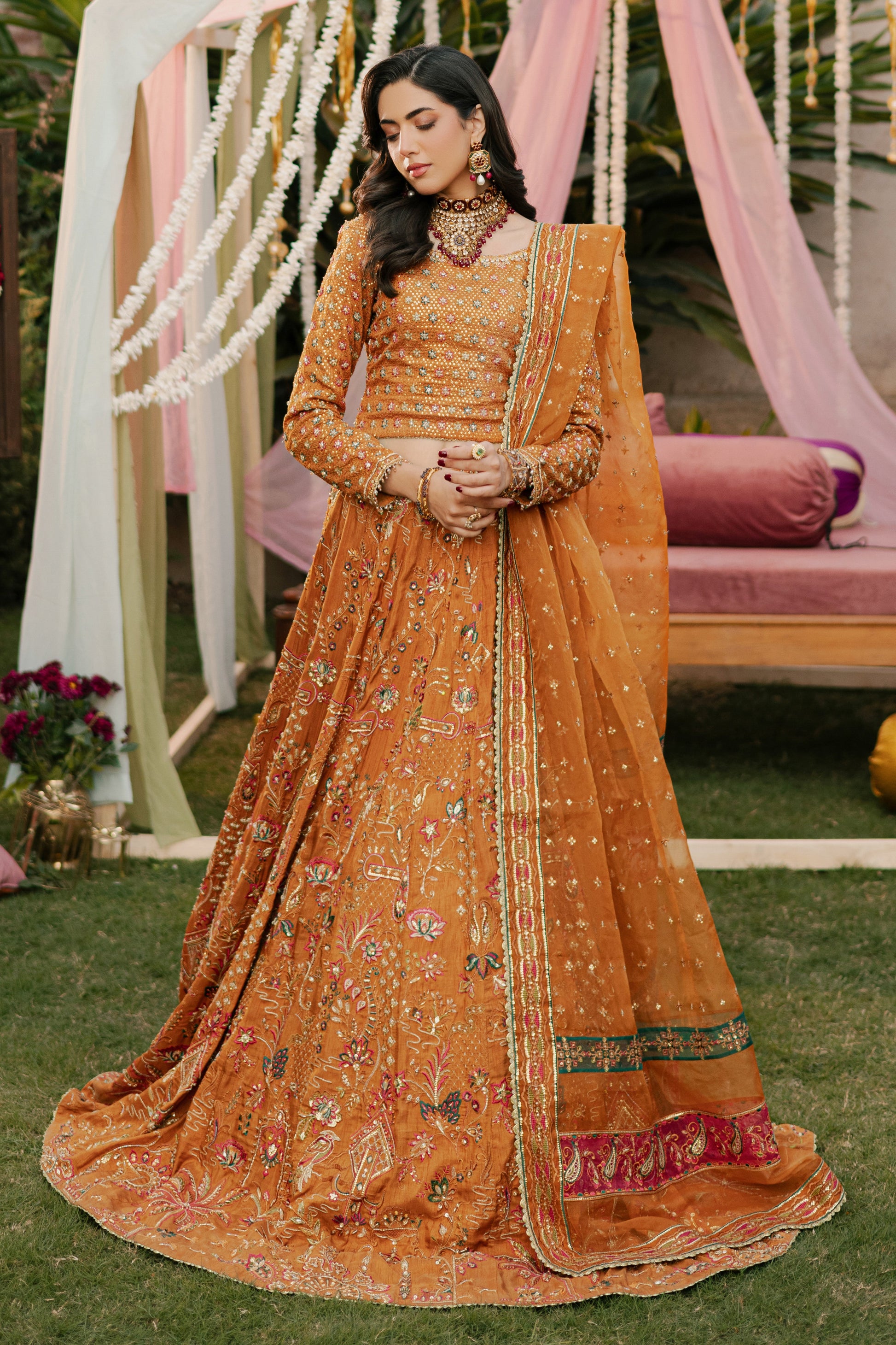 NAQSHI Romanvi tangerine raw‑silk lehenga choli with boat neckline, heavy sequin and textured thread embroidery on bodice, paired with embellished lehenga and organza dupatta