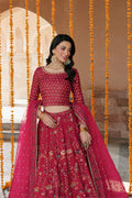 Model wearing full NAQSHI Nageen 3PC: hot‑pink embellished raw‑silk lehenga, sequin‑studded choli with side tassels & embroidered organza dupatta