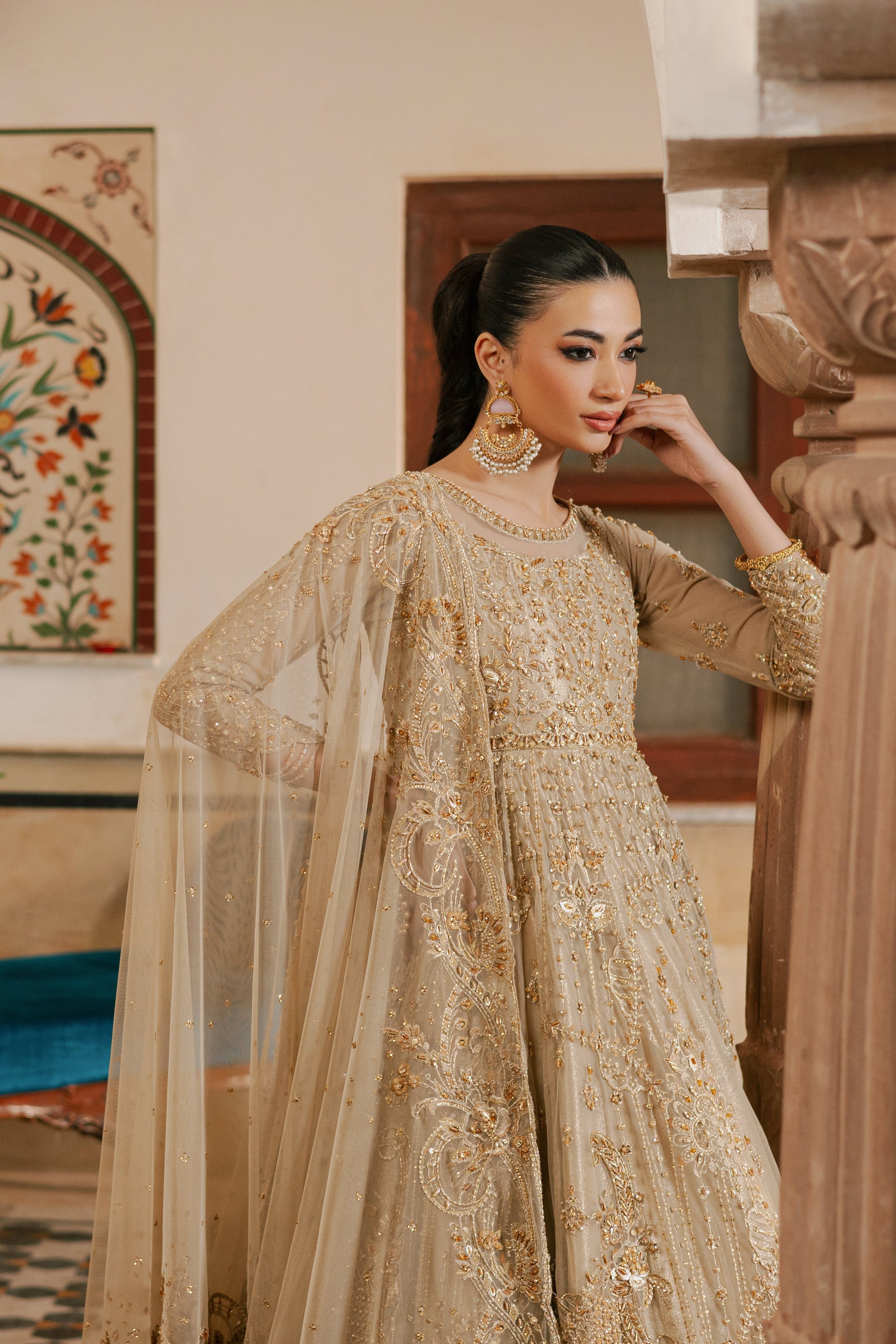 Close‑up of NAQSHI Maneha sleeve embellished with pearls, crystals, sequins, and scalloped net lace edged with hand‑attached crystal tassels
