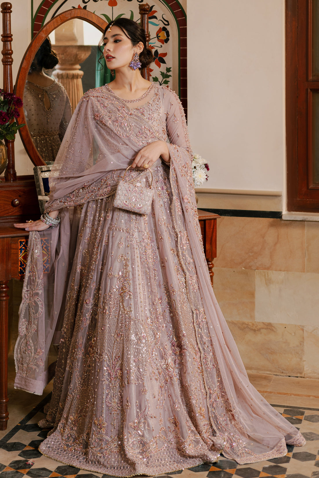 NAQSHI Nihan dusty‑lilac net maxi frock with boat neckline, sheer organza applique, heavy hand embellishments in stones, pearls & crystals across bodice