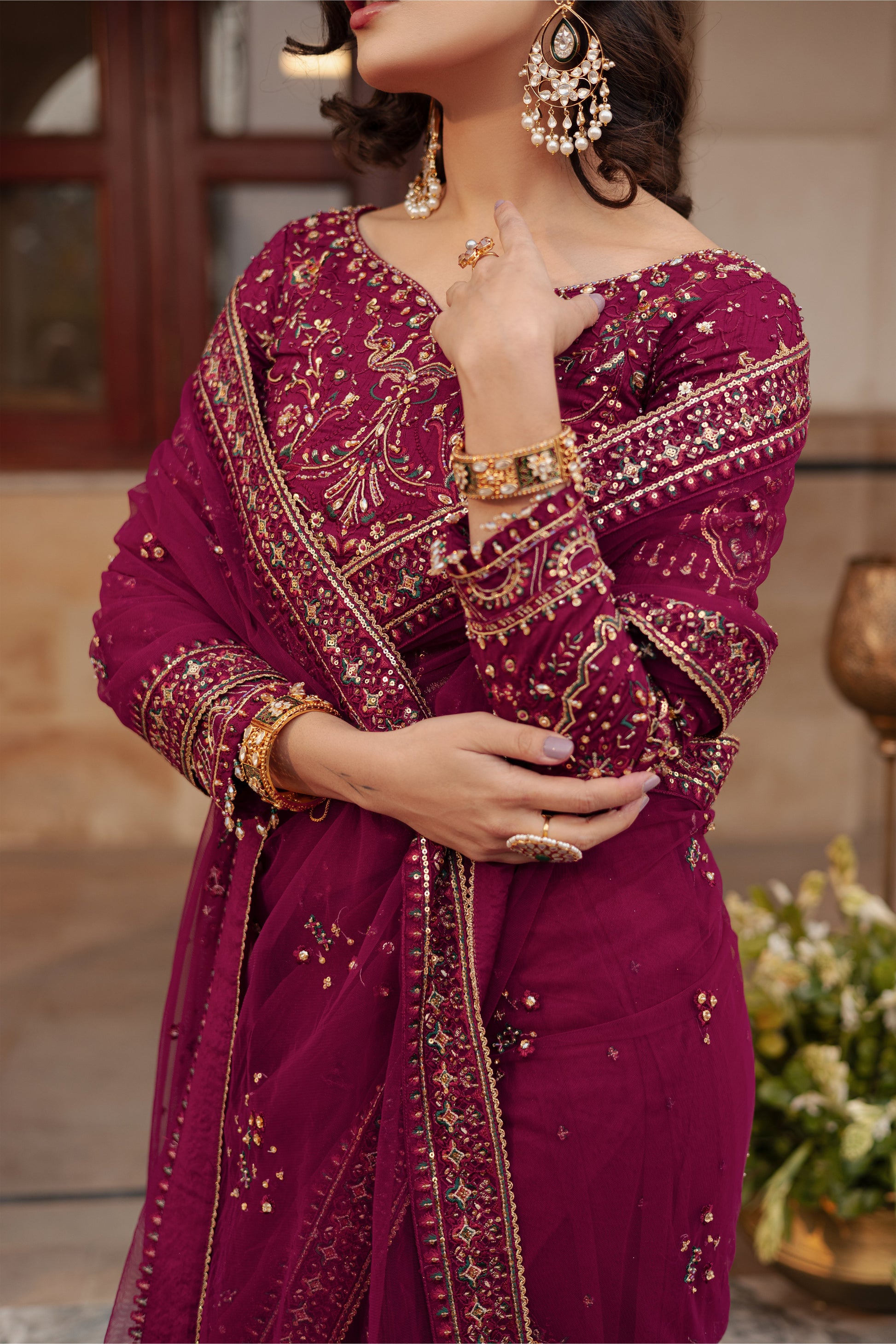 NAQSHI Meeru close‑up of raw silk blouse decorated with hand adda work, sitara, kora, dabka, crystals & thread embroidery around boat neckline